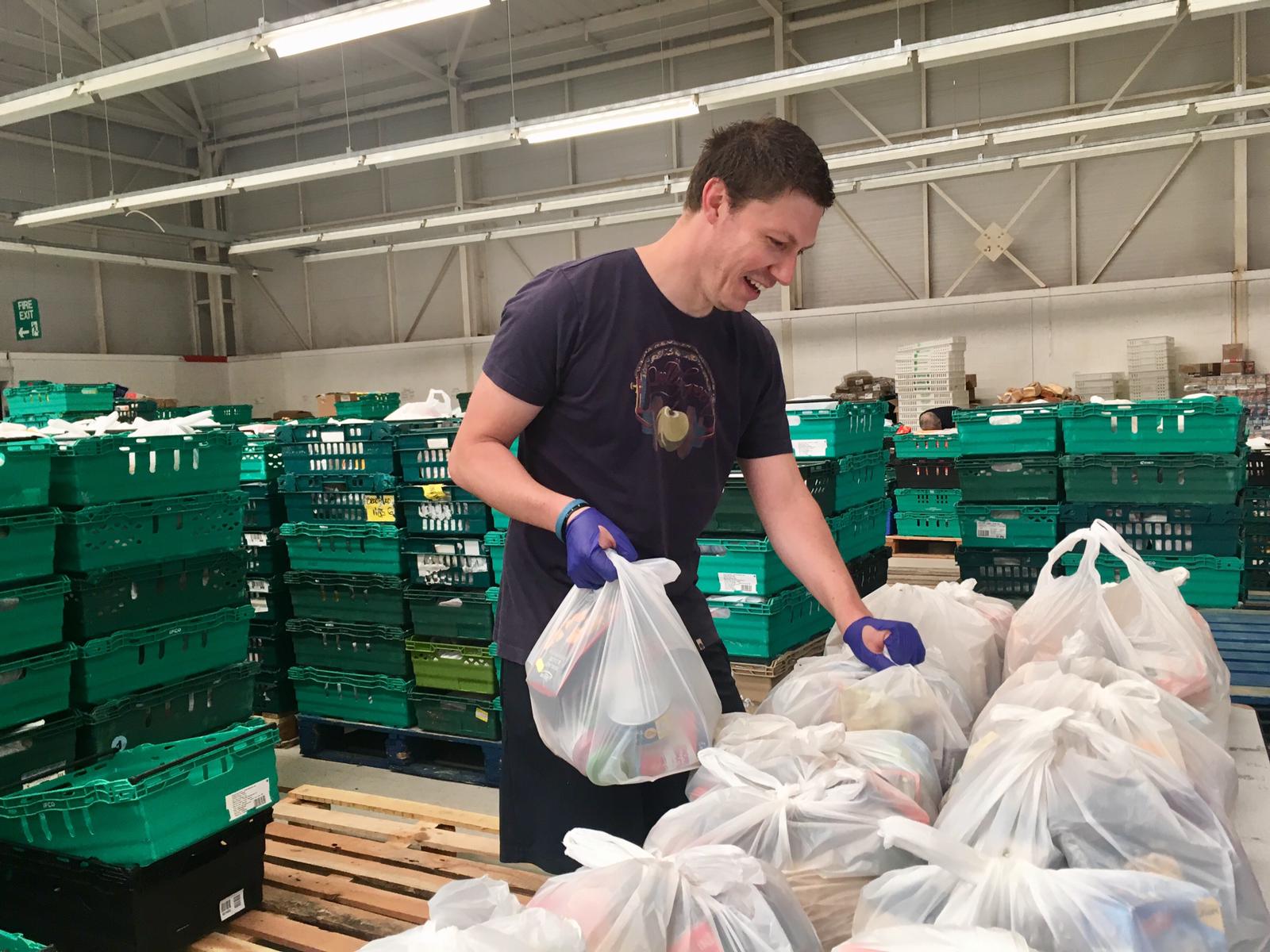 power of one - 4 - volunteer with bags